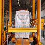 Operai assemblano moduli abitativi prefabbricati in una fabbrica moderna con attrezzature industriali