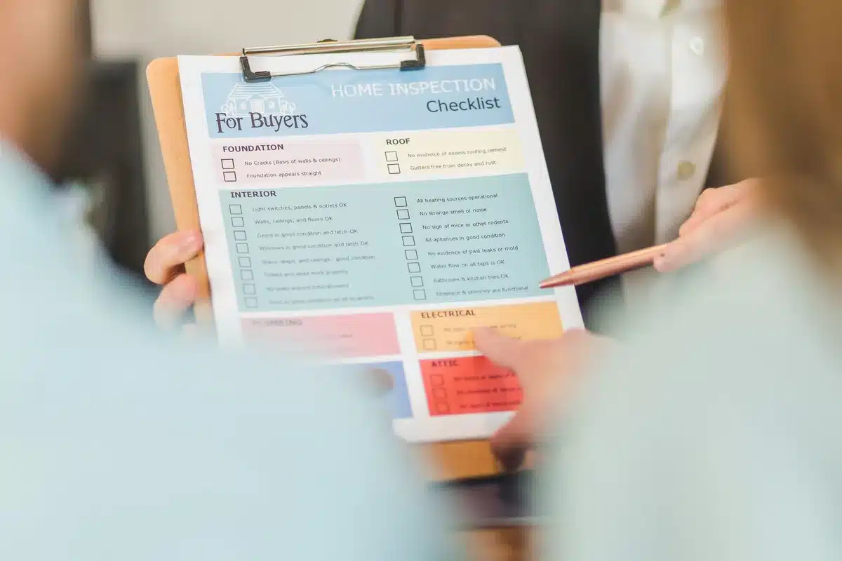 Professionista con checklist durante il sopralluogo tecnico di un immobile costiero